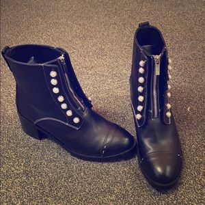 Black combat boots with pearl accents